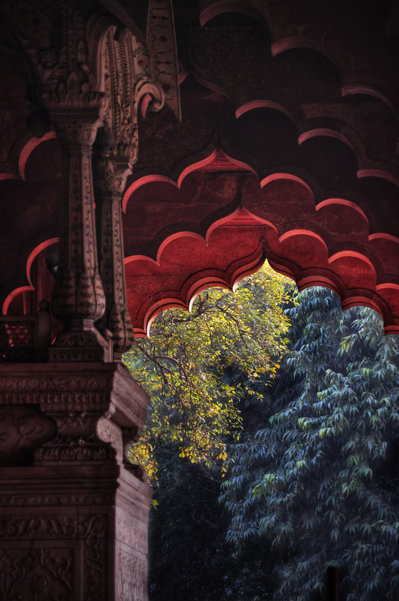 Red Fort arch framing trees, tall portrait