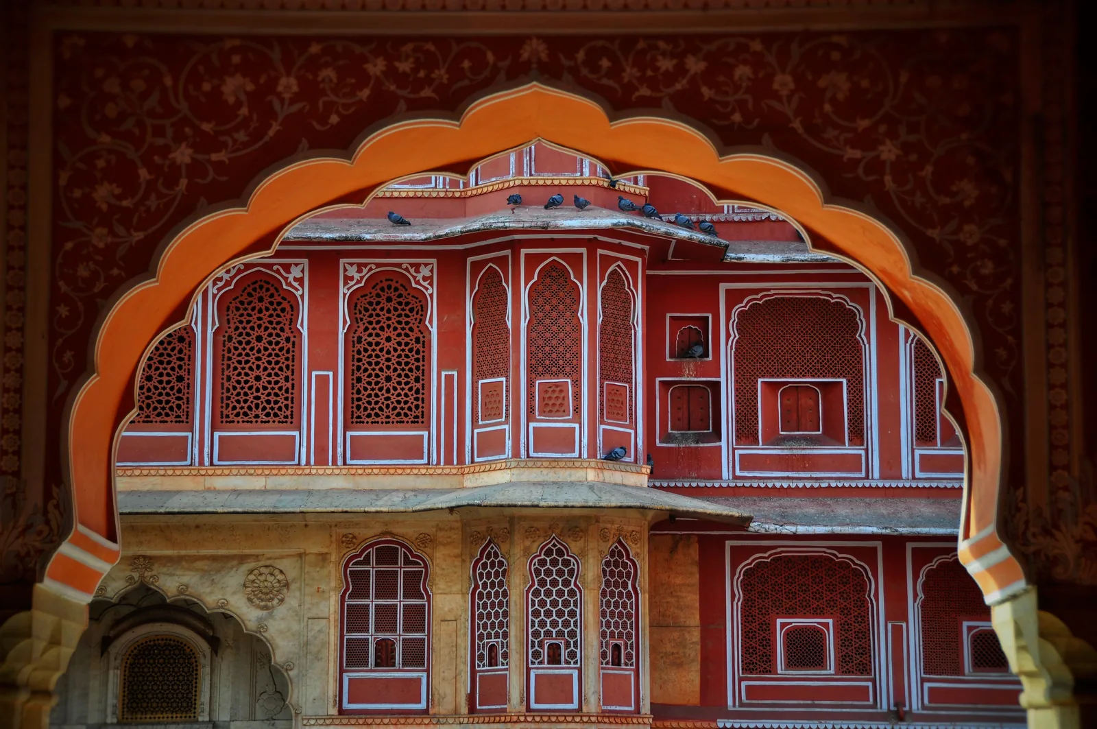 Scalloped arch framing a red palace facade